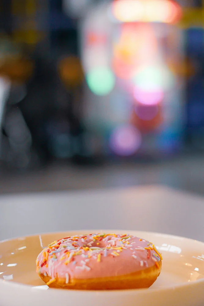 Pink donut and fruit cup from Gum Drops Café